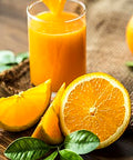 Fresh orange juice with citrus slices and leaves, showcasing vibrant California citrus